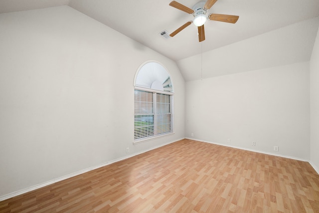 empty room featuring ceiling fan, vaulted ceiling, and light hardwood / wood-style flooring