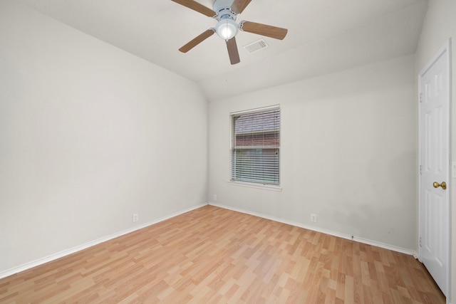 spare room featuring ceiling fan, light hardwood / wood-style flooring, and lofted ceiling