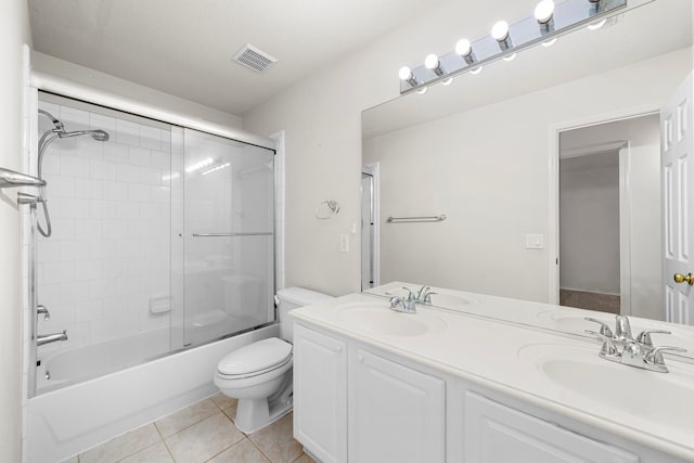 full bathroom with tile patterned flooring, vanity, toilet, and enclosed tub / shower combo