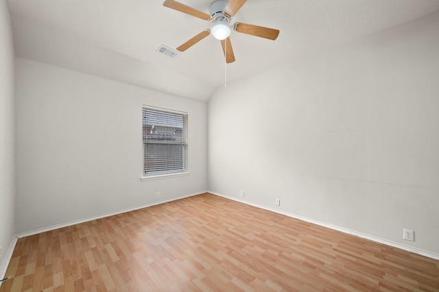 unfurnished room with ceiling fan, light hardwood / wood-style floors, and vaulted ceiling