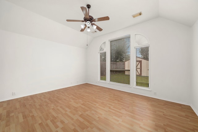 empty room with light wood-type flooring, vaulted ceiling, and ceiling fan