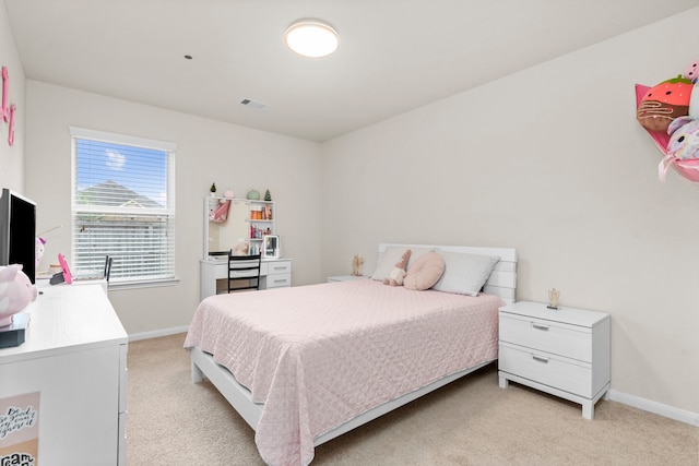 bedroom with light colored carpet