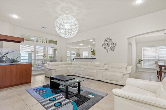 living room featuring light tile patterned floors and a notable chandelier