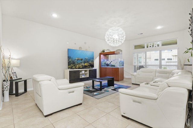 living room with a notable chandelier and light tile patterned flooring