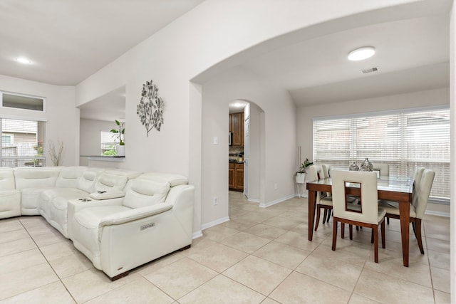 tiled living room with plenty of natural light