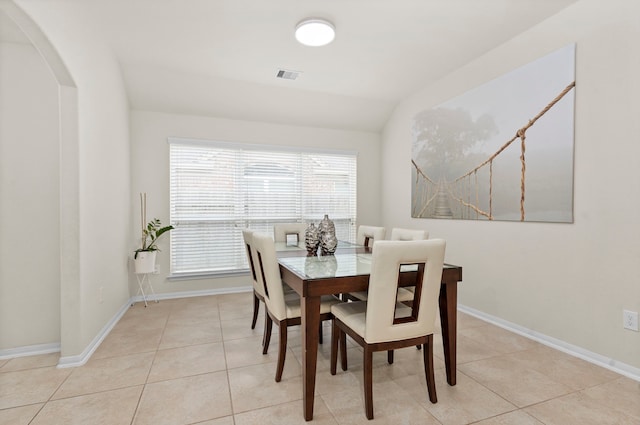 tiled dining area with lofted ceiling