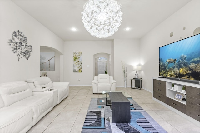 tiled living room featuring a notable chandelier