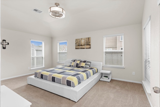 bedroom with carpet floors and lofted ceiling