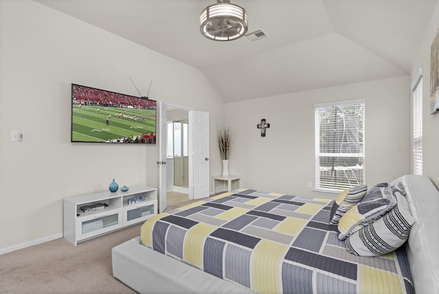 carpeted bedroom with lofted ceiling