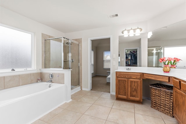 bathroom featuring vanity, tile patterned flooring, plenty of natural light, and plus walk in shower