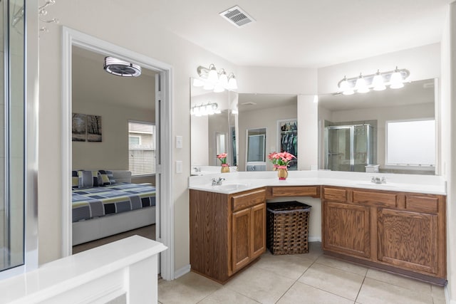 bathroom with tile patterned flooring, an enclosed shower, and vanity