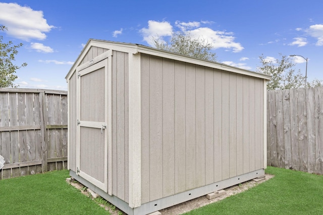 view of outdoor structure featuring a lawn