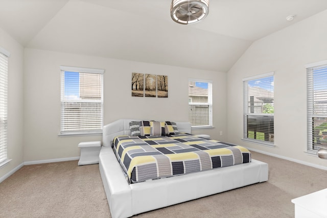 carpeted bedroom with lofted ceiling