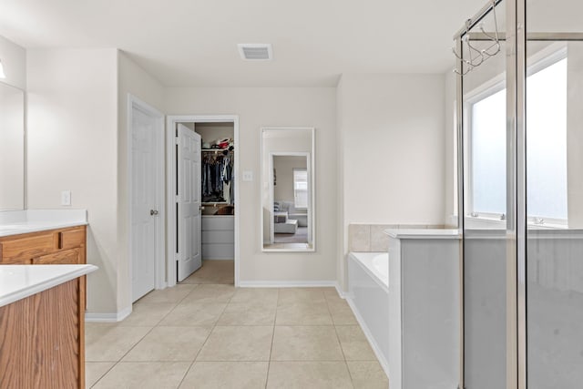 bathroom with independent shower and bath, a chandelier, tile patterned flooring, and vanity