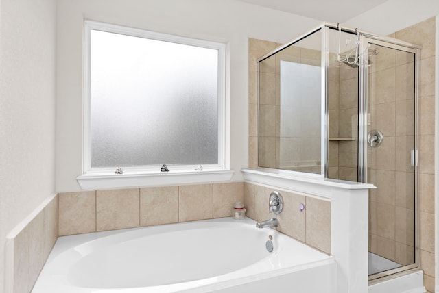 bathroom featuring separate shower and tub