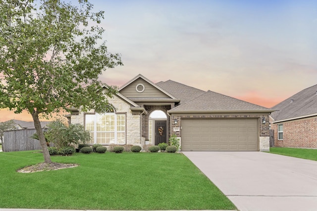 view of front of property featuring a lawn and a garage