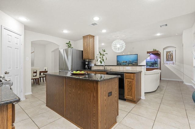 kitchen with dishwasher, light tile patterned flooring, a kitchen island, and stainless steel refrigerator