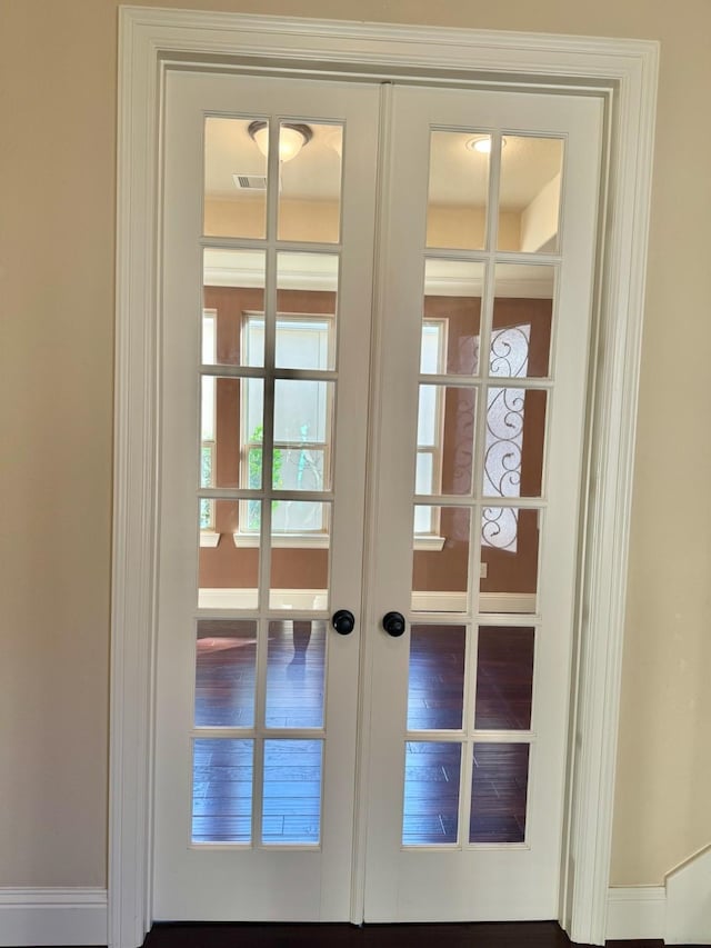 entryway featuring hardwood / wood-style floors and french doors