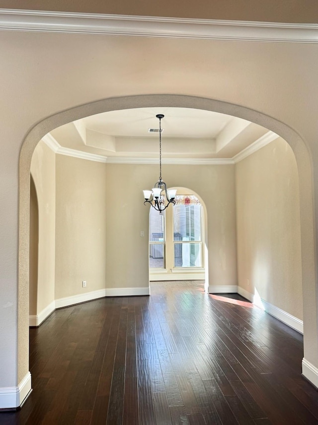 unfurnished dining area with a notable chandelier, a raised ceiling, and ornamental molding