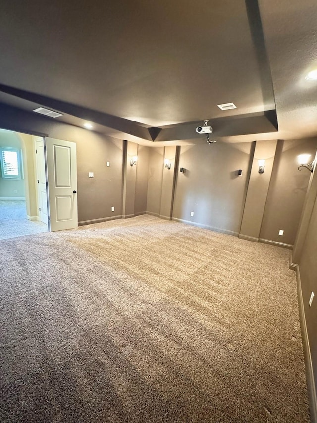 carpeted spare room with baseboards and visible vents