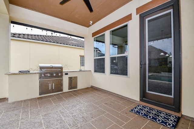 view of patio / terrace featuring a grill, an outdoor kitchen, and ceiling fan