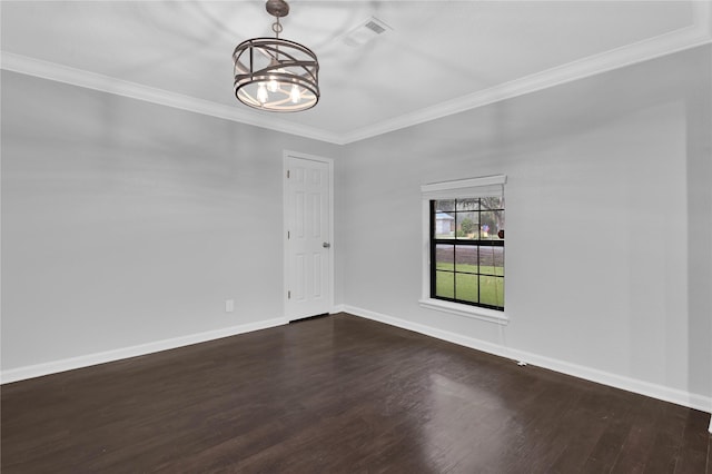 unfurnished room featuring ornamental molding, dark wood-type flooring, and a notable chandelier