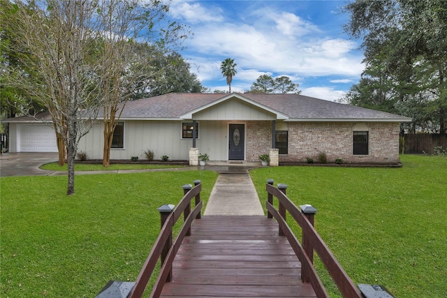 ranch-style home with a garage and a front lawn