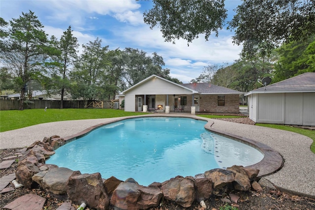 view of pool featuring a yard and a patio