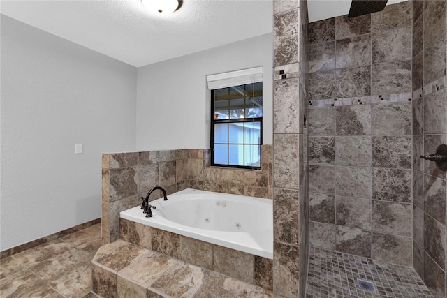 bathroom featuring a textured ceiling and independent shower and bath