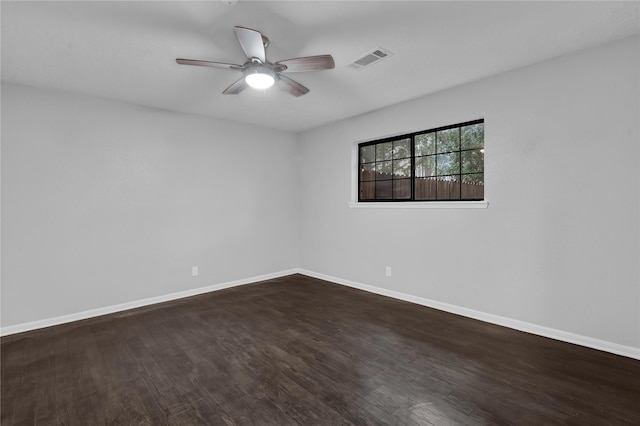 spare room featuring ceiling fan and dark hardwood / wood-style flooring