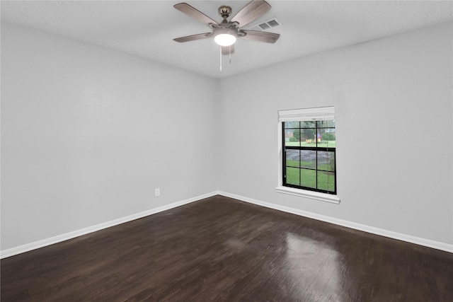 empty room with ceiling fan and dark hardwood / wood-style flooring