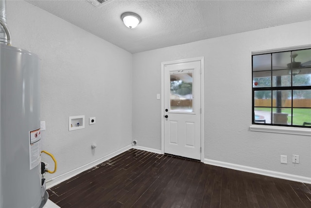 clothes washing area featuring washer hookup, gas water heater, hookup for an electric dryer, dark hardwood / wood-style flooring, and a textured ceiling