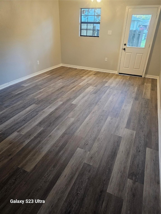 spare room featuring wood-type flooring