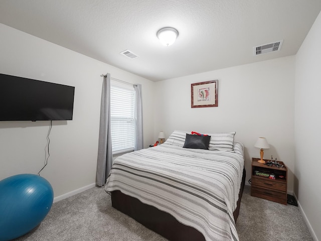 carpeted bedroom with a textured ceiling