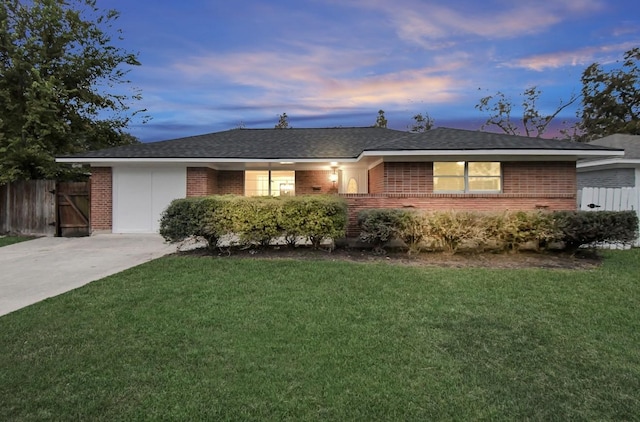 ranch-style home with a lawn