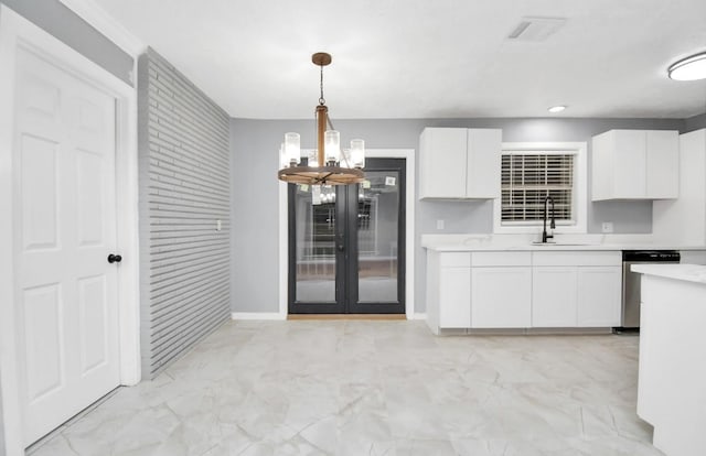 kitchen featuring white cabinets, decorative light fixtures, dishwasher, and a chandelier