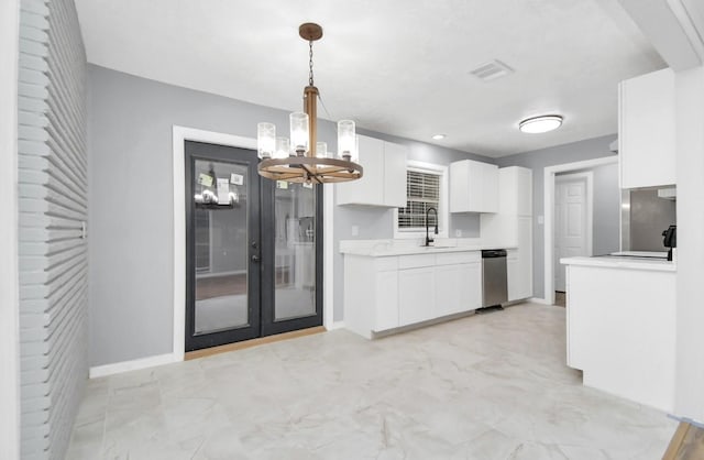 kitchen with white cabinetry, sink, dishwasher, an inviting chandelier, and decorative light fixtures