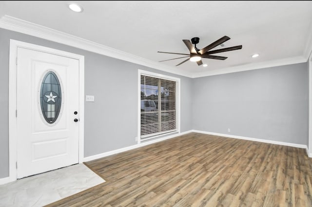 entrance foyer with hardwood / wood-style floors, ceiling fan, and ornamental molding