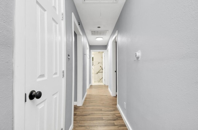 hallway featuring wood-type flooring