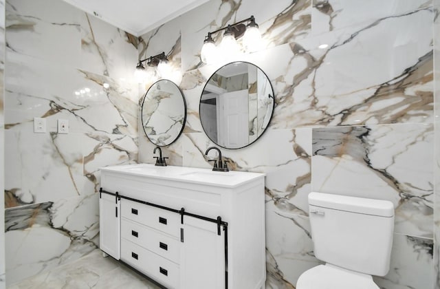 bathroom with vanity, toilet, and tile walls