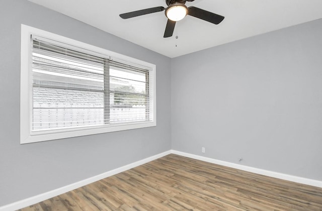 unfurnished room with ceiling fan and hardwood / wood-style flooring