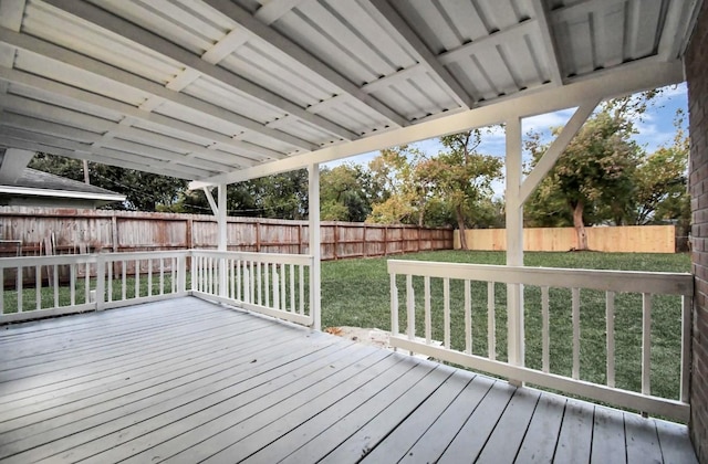 wooden deck featuring a lawn