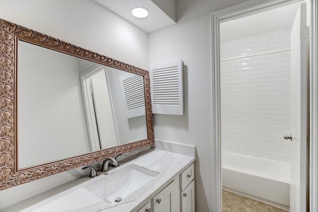 bathroom featuring vanity and tiled shower / bath