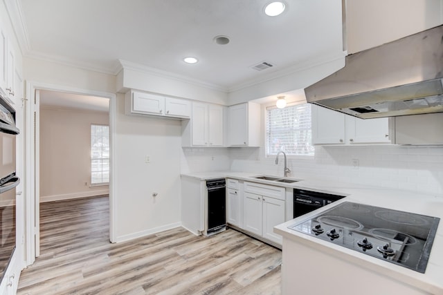 kitchen featuring sink, black appliances, light hardwood / wood-style flooring, white cabinets, and range hood