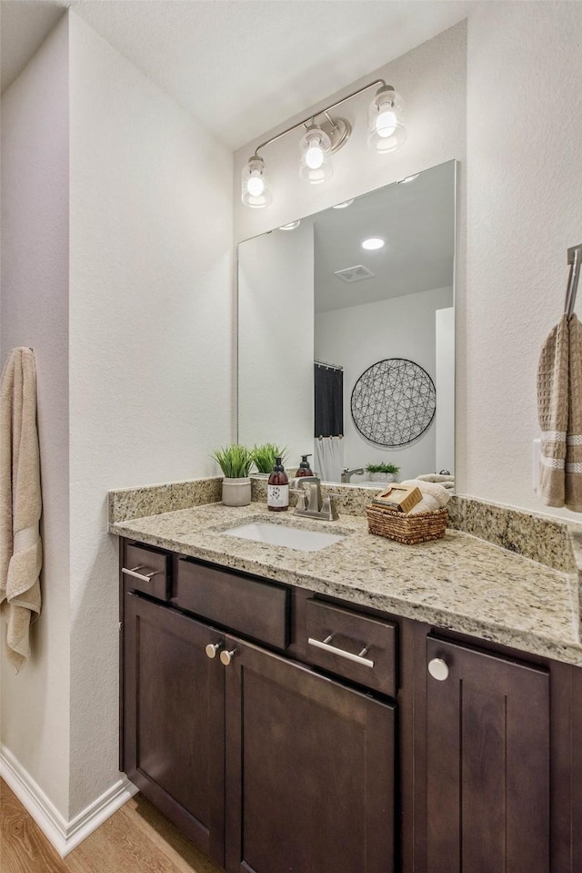 bathroom featuring vanity and wood-type flooring