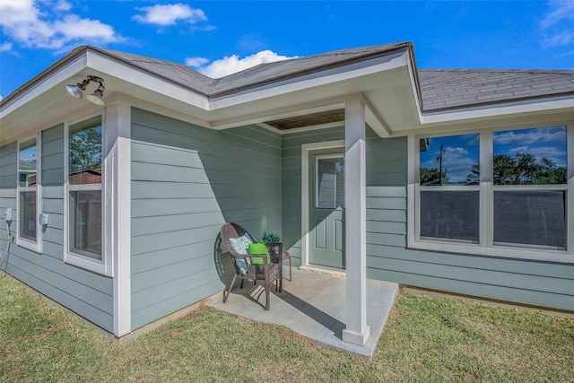 doorway to property featuring a yard