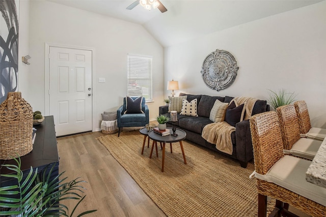 living room with ceiling fan, wood-type flooring, and lofted ceiling