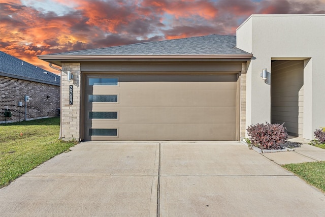 view of garage at dusk