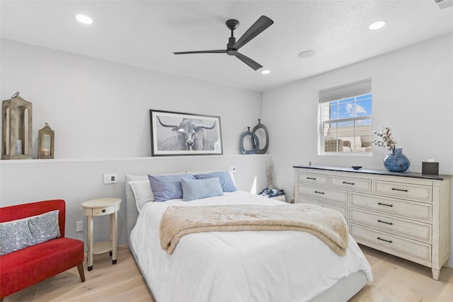 bedroom with ceiling fan and light hardwood / wood-style floors