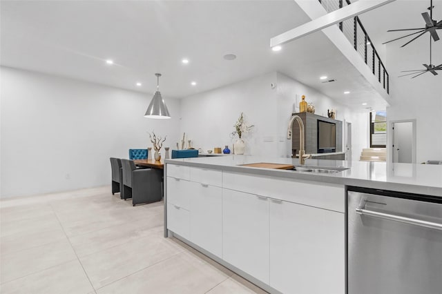 kitchen with decorative light fixtures, ceiling fan, dishwasher, sink, and white cabinets